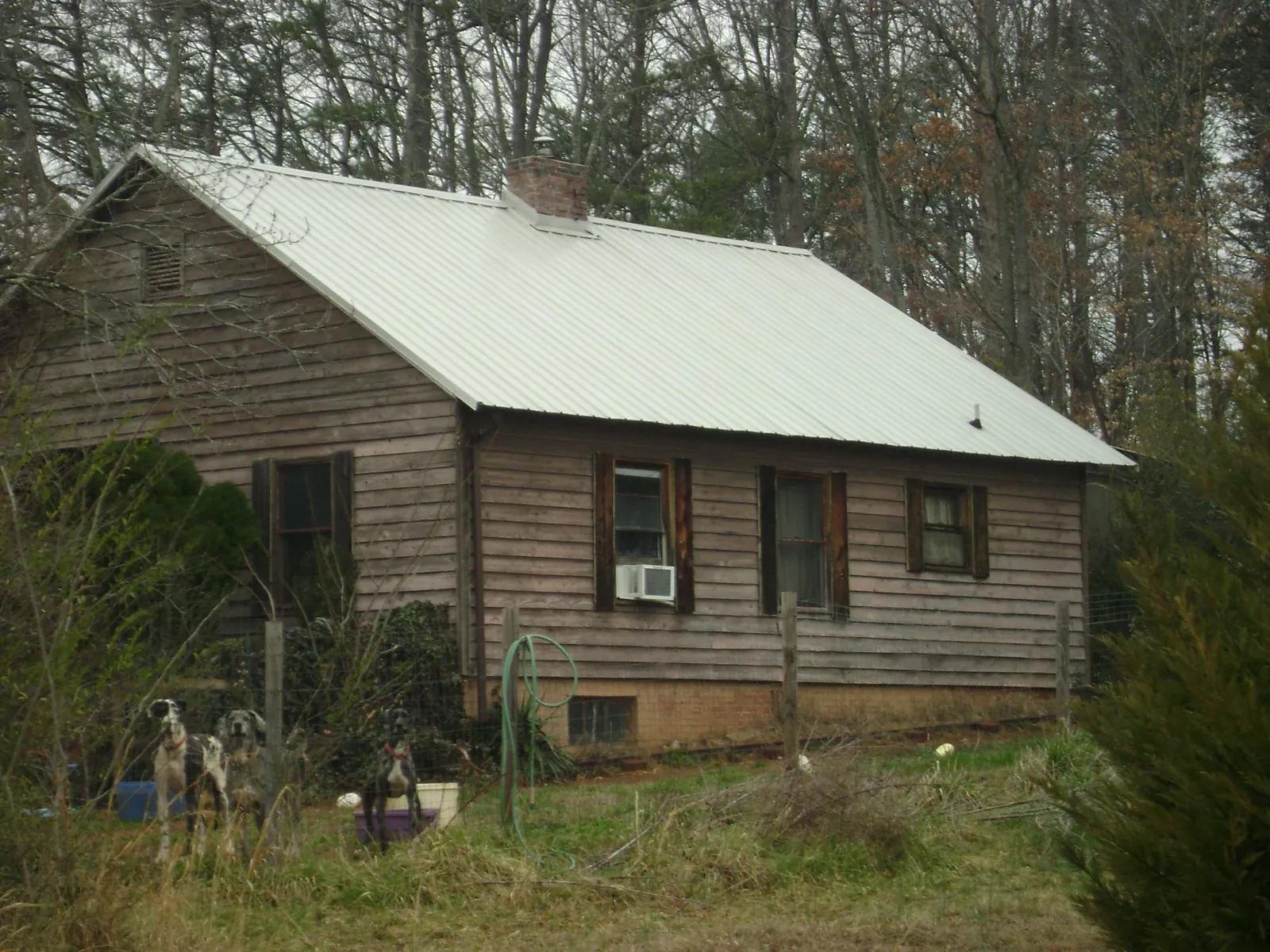 White metal roof on an old wood sided farmhouse, from a Asphalt Shingle Roof Repair job in Wolcottville